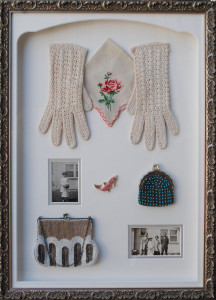 Commemorative shadow box of a mother's gloves, purses and photographs
