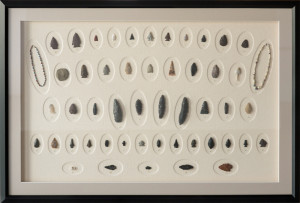 Antique collection of arrow heads in a custom frame