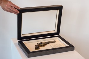 Removable antique gun in custom frame shadow box